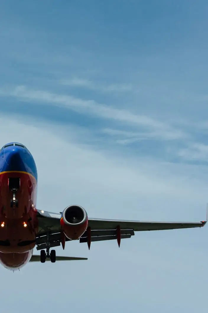blue and red airplane on sky